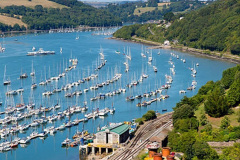 Dartmouth and River Dart harbour Devon England railway station in foreground