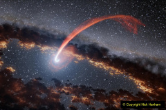 This illustration shows a glowing stream of material from a star as it is being devoured by a supermassive black hole in a tidal disruption flare.