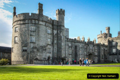 Kilkenny, Ireland - October 31, 2013 : People are walking by the left wing of the Kilkenny Castle.