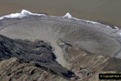 Alluvial fan spilling onto flooded playa, Death Valley, California. White rim of fan consists of salt (halite) deposits. (2K5-2666)